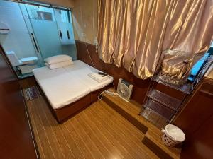 a small room with a small bed on a boat at 3D Inn Hong Kong - Dragon in Hong Kong