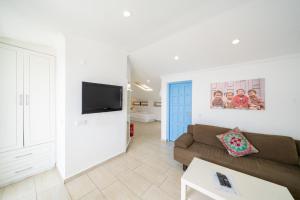 a living room with a couch and a tv at Yoga House Kaş in Kaş