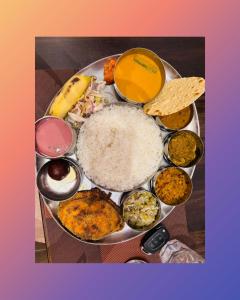 a plate of food with rice and other foods at Yash-Deep - 100 meter Calangute Beach in Calangute