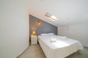 a bedroom with two beds with white sheets at Yoga House Kaş in Kaş