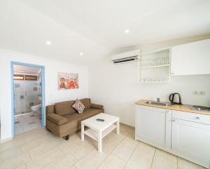 a kitchen and a living room with a couch and a table at Yoga House Kaş in Kaş