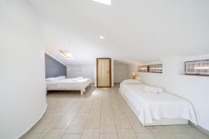 a hotel room with two beds and a bathroom at Yoga House Kaş in Kaş