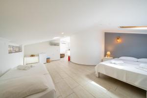 a white bedroom with two beds and a hallway at Yoga House Kaş in Kaş +37 photos