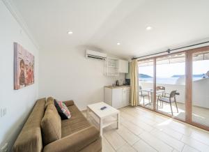 a living room with a couch and a table at Yoga House Kaş in Kaş