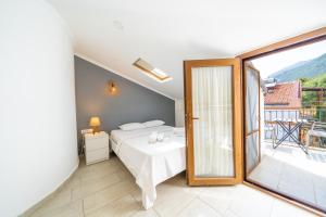 a bedroom with a bed and a balcony at Yoga House Kaş in Kaş
