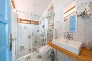 a bathroom with a sink and a shower and a toilet at Yoga House Kaş in Kaş