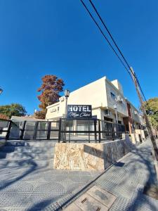 a hotel sign in front of a building at Hotel Mon Chéri in Villa Carlos Paz