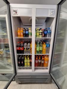 a refrigerator filled with lots of different types of drinks at Hotel Mon Chéri in Villa Carlos Paz