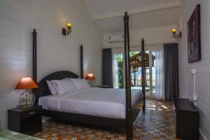 a bedroom with a large bed in a room at Larisa Beach Resort in Morjim