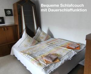 a bedroom with a bed with two books on it at Ferienwohnung Katharina I in Alf