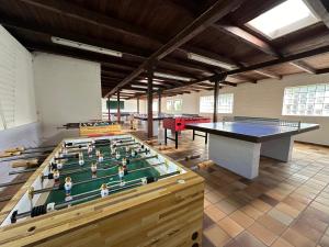 a large room with ping pong tables in it at Haus Klaarstrand in Wenningstedt