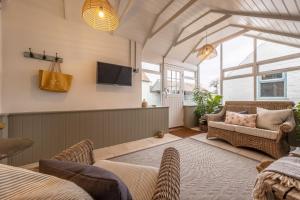 ein Wohnzimmer mit einem Sofa und einem TV in der Unterkunft The Beekeepers Cottage in Barney