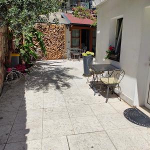 a patio with a table and chairs next to a building at Garda Sweet Apartments in Arco +21 photos