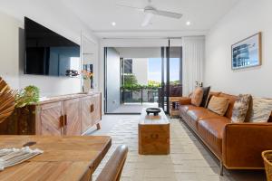 a living room with a couch and a table at Seanna Residences Bokarina Beach in Kawana Waters