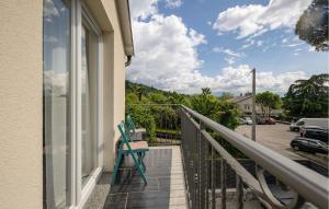 a balcony with a chair and a view of a parking lot at 2 Bedroom Cozy Apartment In Rukavac in Rukavac