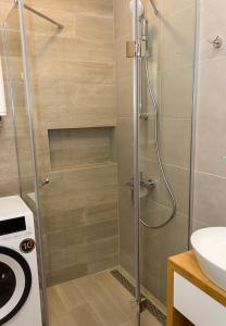 a shower with a glass door in a bathroom at Azur Delux -1BD Flat with Parking & Pool by Flat Mаnаger in St. St. Constantine and Helena