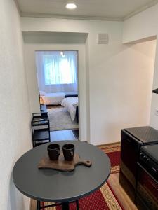a room with a table with two cups on it at Karula Stay 1-Room Apartment in Antsla