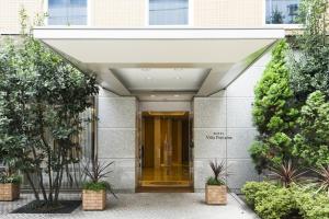 an entrance to a building with awning and plants at Hotel Villa Fontaine Tokyo-Hamamatsucho in Tokyo