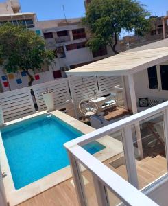 a balcony with a swimming pool on top of a building at As Hortênsias in Mindelo