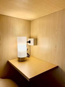a lamp on a wooden shelf in a room at Casa Tavano in Avola