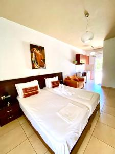 a bedroom with a large white bed in a room at Villa Marianna in Parga