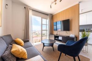 ein Wohnzimmer mit einem Sofa und einem TV in der Unterkunft Callao sunset apartment, sea view and pool in Callao Salvaje