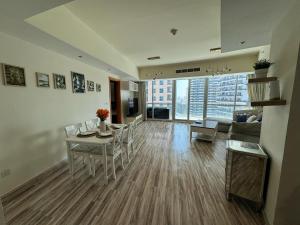 a living room with a table and chairs and a couch at 2 Bedroom & 3 Bath Apartment in Dubai Marina - walking distance to JBR!" in Dubai