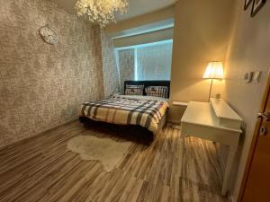 a small bedroom with a bed and a desk at 2 Bedroom & 3 Bath Apartment in Dubai Marina - walking distance to JBR!" in Dubai