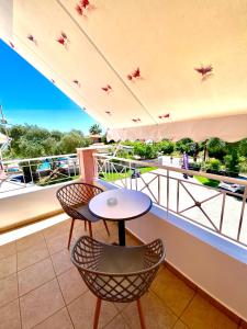 a balcony with a table and chairs on a boat at Villa Marianna in Parga