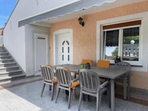 a dining room table and chairs on a patio at Holiday home Biondic in Krk