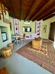 a living room with a table and a rug at Sezz Hotels Spa Wellness Yalikavak Adult Only in Yalıkavak