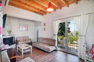a living room with a couch and a fireplace at Villa Sotiria in Néa Thésis