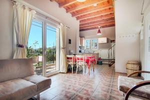 a living room with a couch and a table with chairs at Villa Sotiria in Néa Thésis