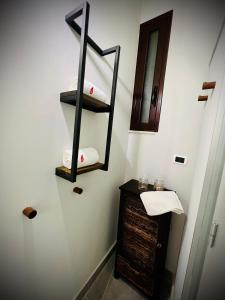 a bathroom with a towel rack and a mirror at Sun Apartments in Agrigento