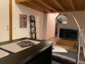 a living room with a desk with a tv and a table at Loft in Viljandi Old Town in Viljandi +11 photos