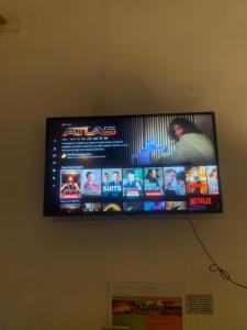 a flat screen television hanging on a wall at The Real Place Hostel in Battambang