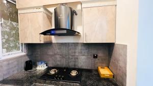 a kitchen with a stove top oven in a kitchen at Residential Apartment Complex El-cilo B 414 in Islamabad