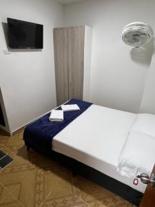 Rúm í herbergi á Hotel Coffee Real Pereira