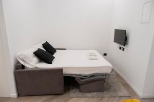 a bed in a room next to a chair at barneys design apartment in Taranto