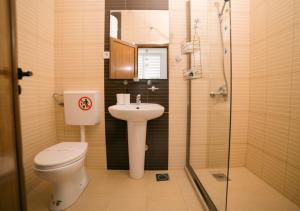 a bathroom with a toilet and a sink and a shower at Apartments Lungo Mare Ulcinj in Ulcinj +143 photos