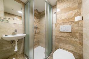 a bathroom with a shower and a toilet and a sink at Botel Albatros in Prague +37 photos