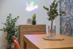 a dining room table with two chairs and a wooden table with a table at Central Belfast Apartments Somerset Mews in Belfast