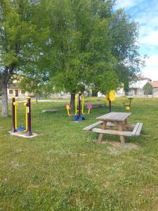 a picnic table and playground equipment in a park at Casa Rural El Brocense - Navamorales in Navamorales