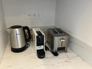 a kitchen counter with a coffee maker and a blender at Camelia in Belgirate