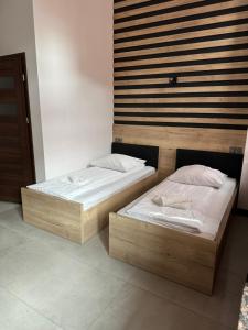 Łóżko lub łóżka w pokoju w obiekcie Aparthotel Łódź 55 Piotrkowska