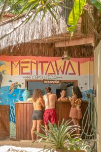 a group of people standing at a bar at Eco Pousada Mentawai in Itacaré