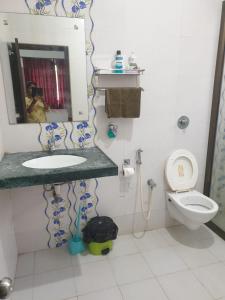 a bathroom with a sink and a toilet at Palolem garden estate in Canacona