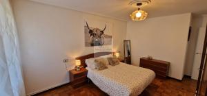a bedroom with a bed and a picture of a bull on the wall at Villa Rodiles - Vistas al mar - Wifi - 5 hab - 4 baños - Garaje - VV-2979-AS in Liñero