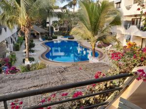 a view of the pool from the balcony of a hotel at l'Eden in Saly Portudal
