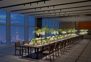a long table in a room with a view of a city at Mandarin Oriental, Shenzhen in Shenzhen